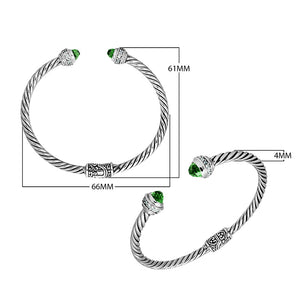 Sterling silver wholesale bangle with twisted rope design, featuring Green Quartz and Cubic Zirconia end caps with Balinese motifs.