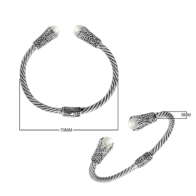 Sterling silver twisted bangle with pearl ends and Balinese carvings, handcrafted in Bali