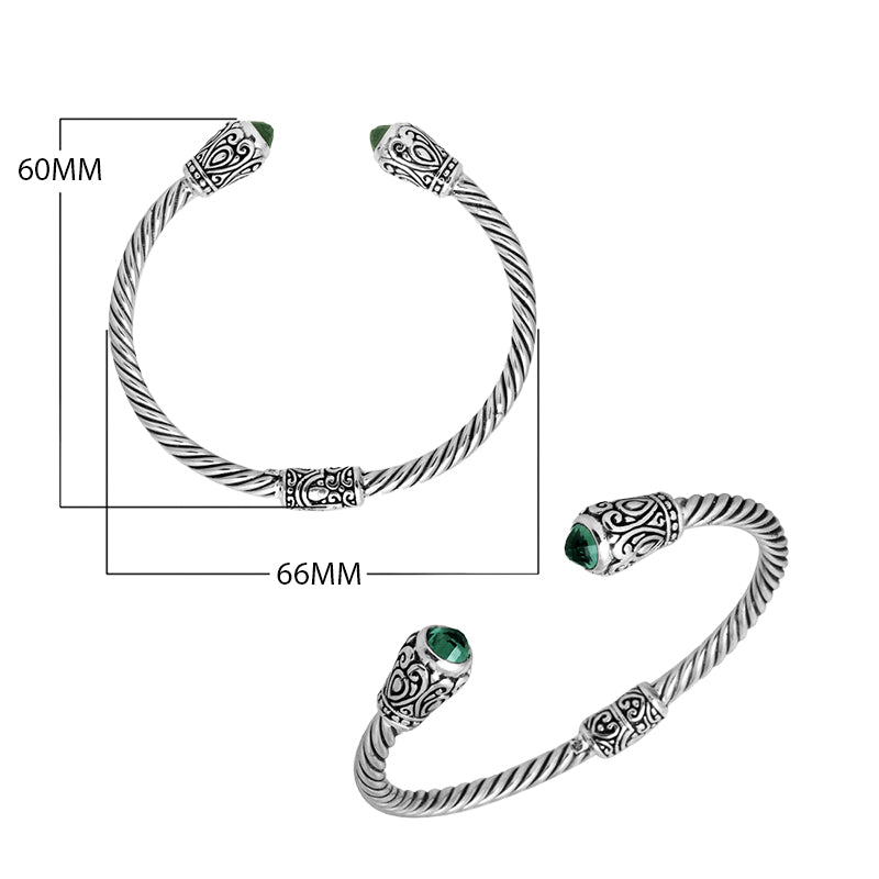 Sterling silver twisted bangle with green quartz ends and Balinese carvings, handcrafted in Bali