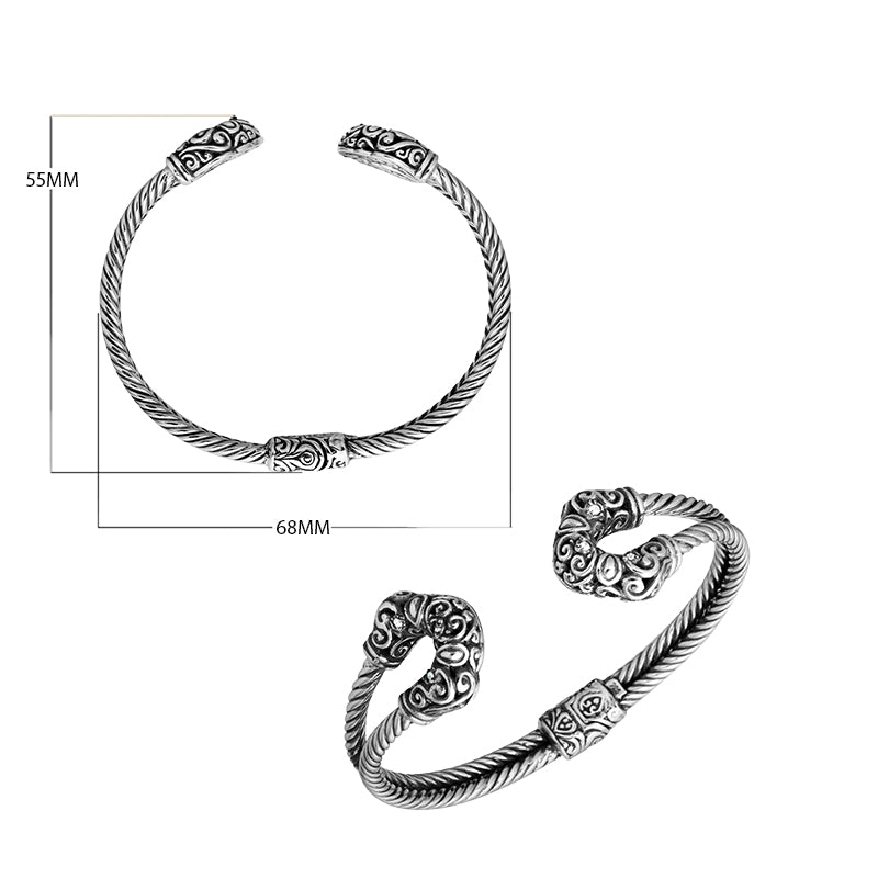 Sterling silver twisted bangle with cubic zirconia ends and Balinese carvings, handcrafted in Bali