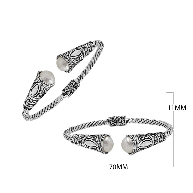 Sterling silver twisted bangle with pearl ends and oxidized Balinese design