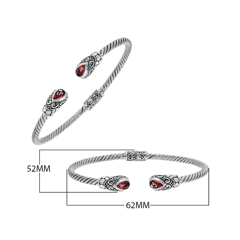 Silver twisted cable bangle in 925 sterling silver with pear-shaped Garnet Quartz and Balinese scroll engraving.
