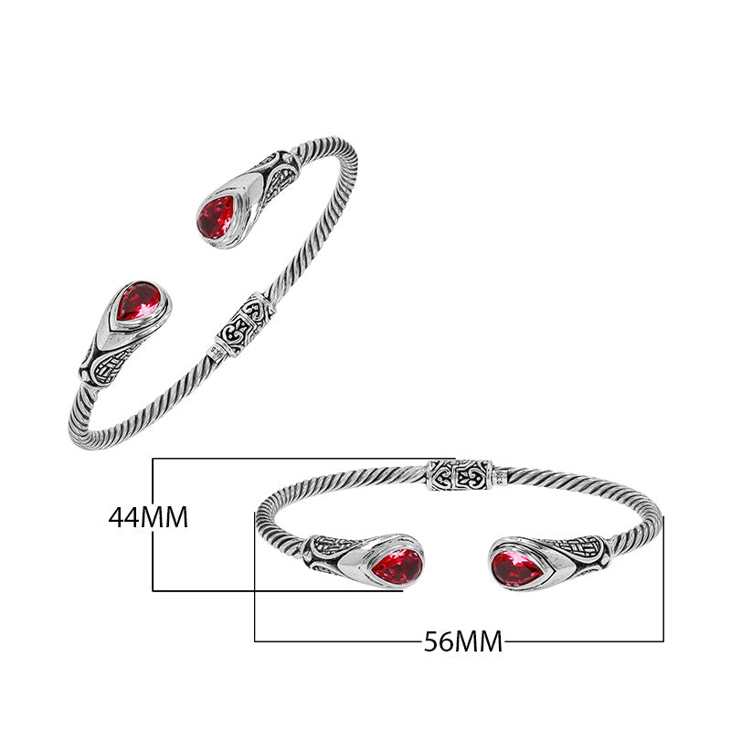 Silver twisted cable bangle in 925 sterling silver with Garnet Quartz ends and Balinese engraving.