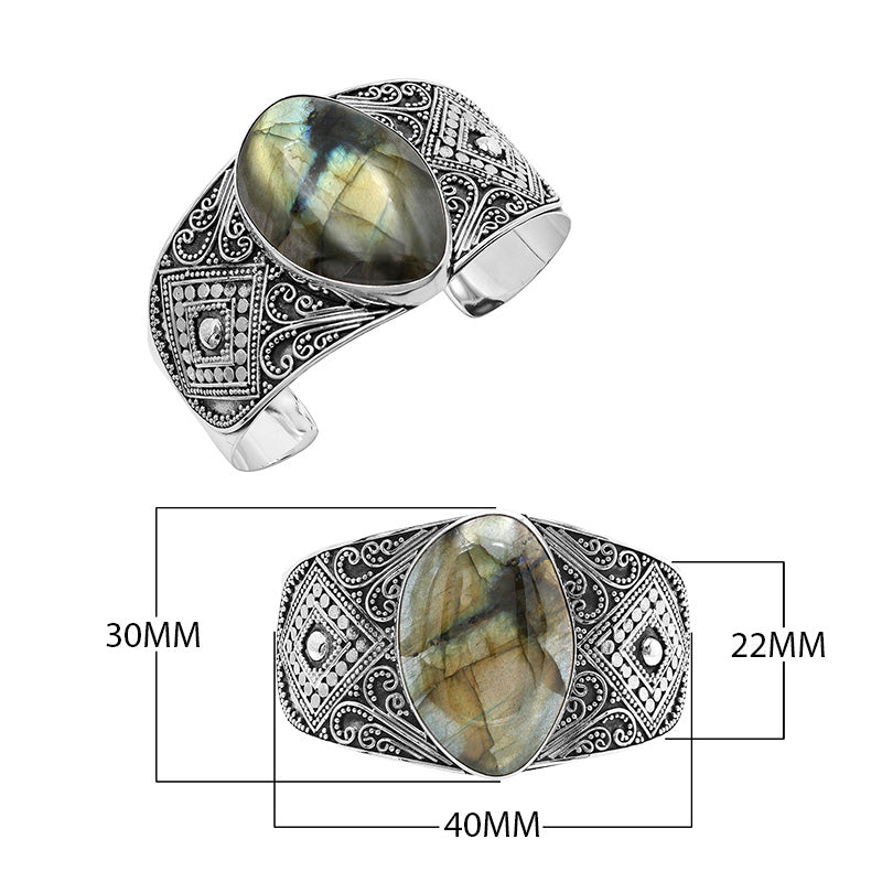 925 sterling silver wide Balinese bangle with Labradorite centerpiece and ornate scroll detailing.