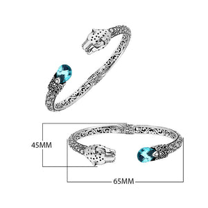 Sterling silver panther head cuff bangle with blue topaz quartz ends and floral carving handcrafted in Bali.