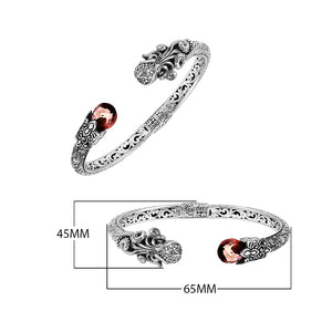 Sterling silver dragon head cuff bangle with garnet quartz ends and floral carvings handcrafted in Bali.