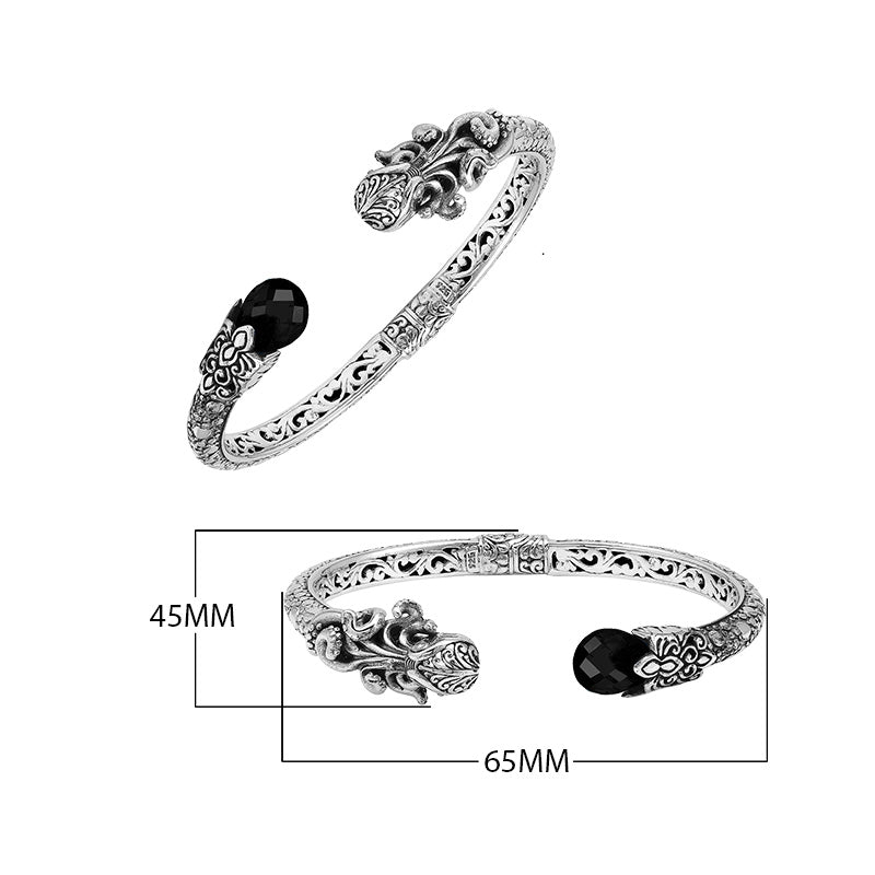 Sterling silver dragon head cuff bangle with black onyx ends and floral carvings handcrafted in Bali.