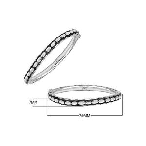 Sterling silver medium-size bangle featuring bold oval textured detailing, polished and oxidized finish, and secure hinge lock with safety latch for wholesale jewelry buyers.