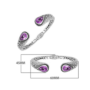 Sterling silver bangle featuring teardrop amethyst quartz stones, detailed Bali engraving, oxidized texture, and a secure hinge lock designed for premium wholesale jewelry collections.