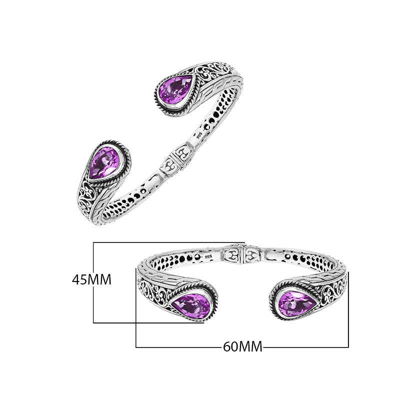 Sterling silver bangle featuring teardrop amethyst quartz stones, detailed Bali engraving, oxidized texture, and a secure hinge lock designed for premium wholesale jewelry collections.