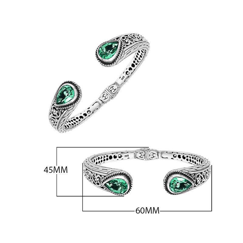 Wholesale sterling silver hinge-lock cuff with green quartz teardrop stones and Balinese engravings.