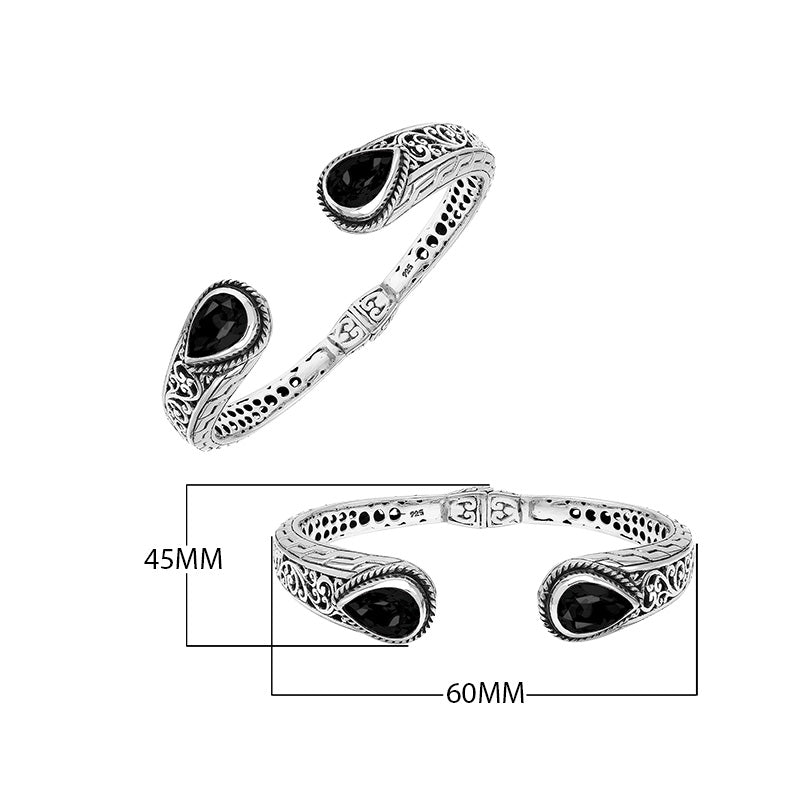 Wholesale sterling silver cuff with black onyx teardrop stones and ornate Balinese carving.