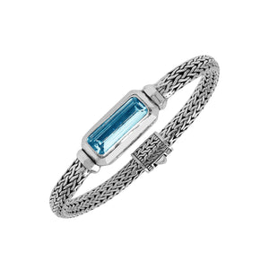 Sterling Silver woven bracelet featuring a polished push clasp and a rectangular Blue Topaz Quartz centerpiece, crafted with detailed metalwork for an elegant and durable wholesale-ready presentation.