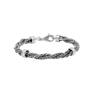 Sterling Silver bracelet featuring a twisted woven chain design with polished metal connectors and a secure lobster clasp, crafted for durable and elegant wholesale presentation.