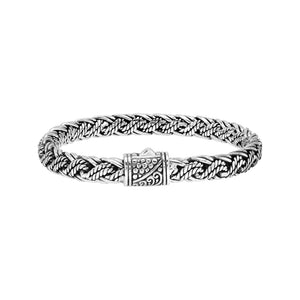 Sterling silver twisted rope chain bracelet featuring wrapped textured links, deep oxidized accents, polished detailing, and an engraved decorative push clasp.