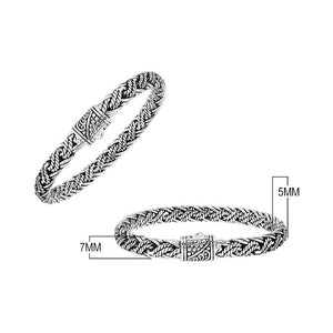 Sterling silver twisted rope chain bracelet featuring wrapped textured links, deep oxidized accents, polished detailing, and an engraved decorative push clasp.