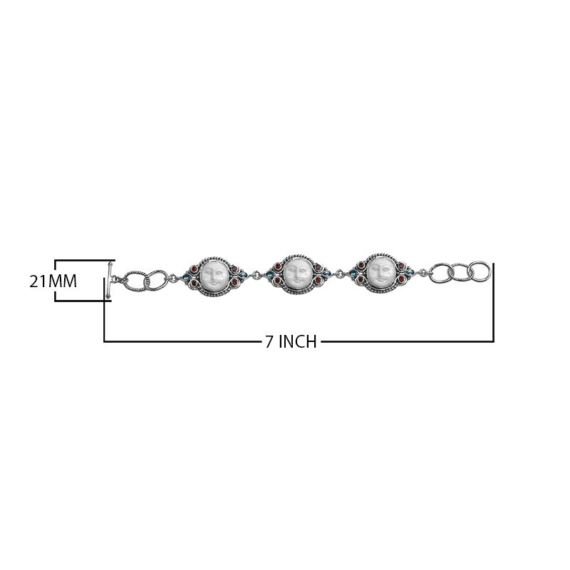 Sterling silver bracelet featuring carved bone faces with Garnet Quartz and Blue Topaz Quartz accents and an artisan toggle lock.