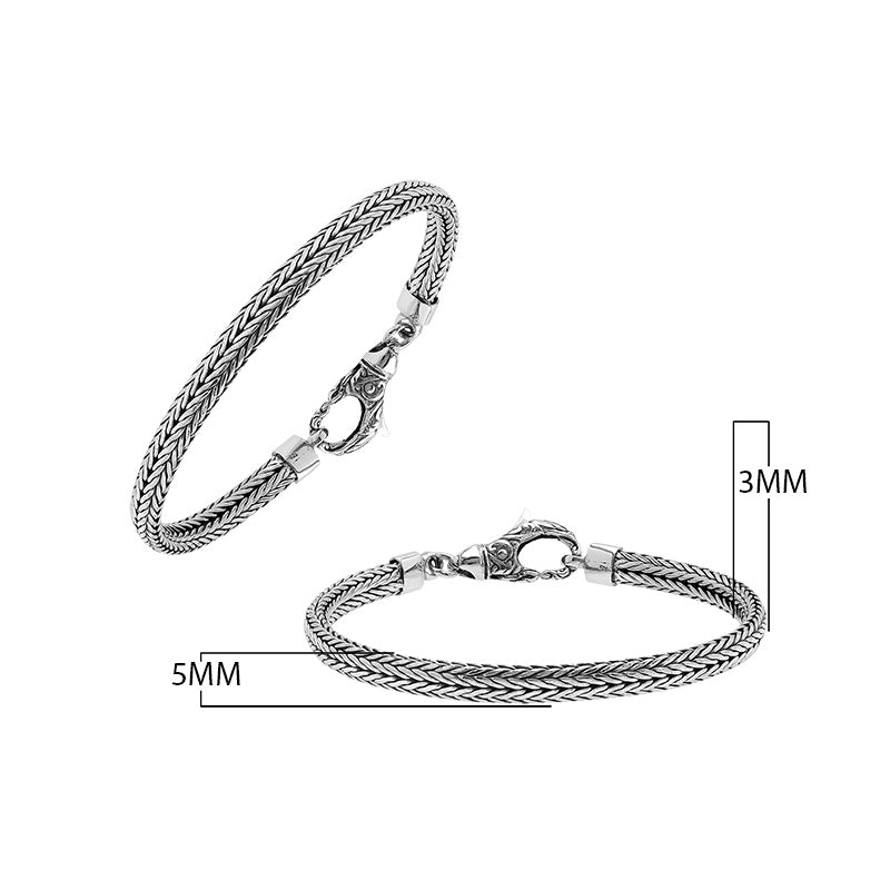 A beautifully crafted sterling silver woven bracelet with a secure lobster clasp, featuring intricate chain detailing and a mirror-polished high-gloss finish for elegant collections.