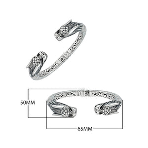 Wholesale sterling silver phoenix bangle featuring Mother of Pearl accents, detailed Balinese scroll carving, and a secure hinge lock ideal for premium artisan jewelry collections.