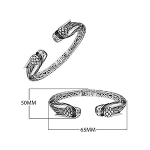 Wholesale sterling silver phoenix bangle featuring Black Shell insets, ornate Balinese scroll carving, and a sturdy hinge lock, crafted for premium artisan wholesale jewelry assortments.