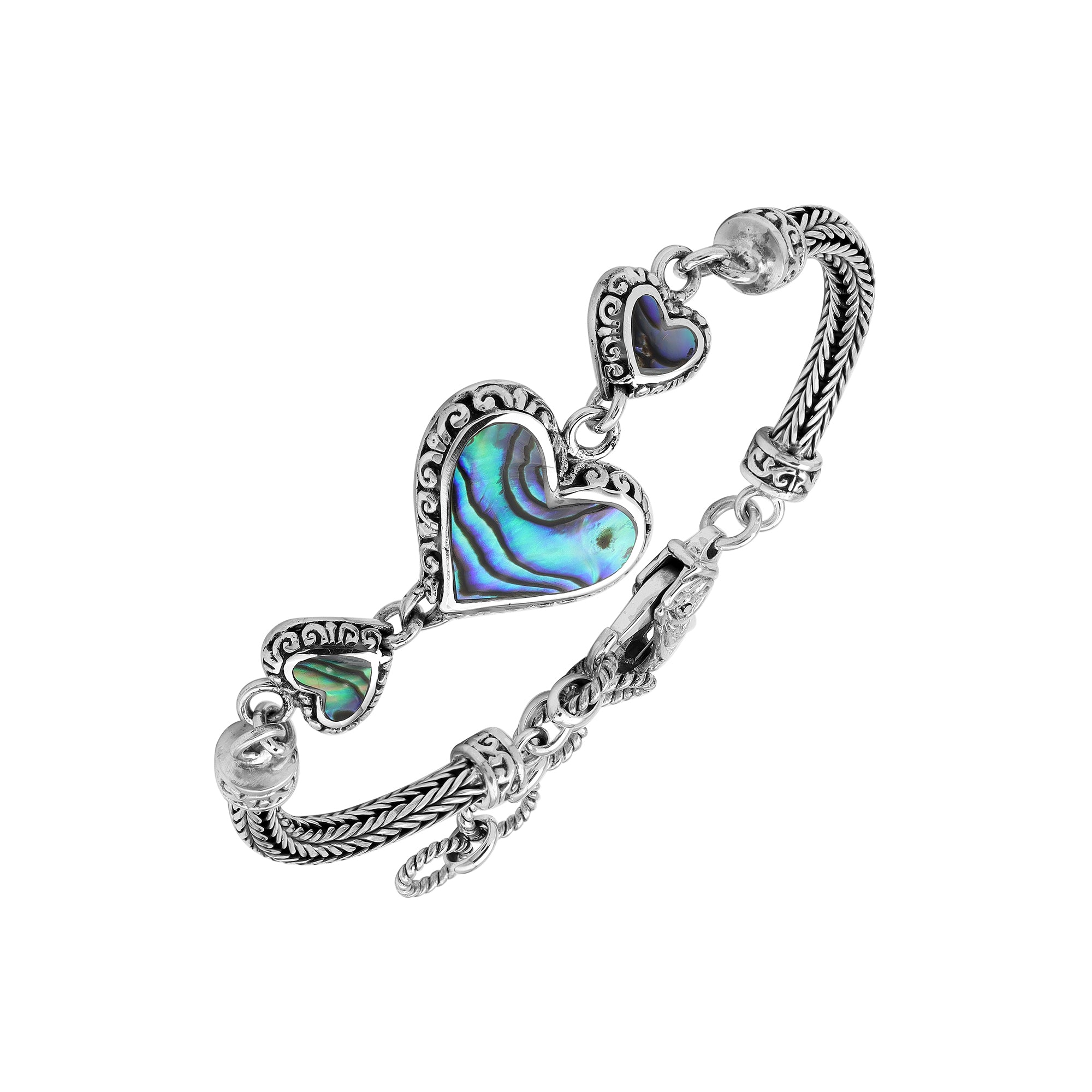 Wholesale sterling silver bracelet featuring Abalone Shell heart links, intricate Balinese decorative detailing, and a secure lobster lock for premium artisan-style jewelry collections.
