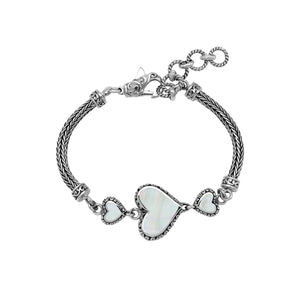 Wholesale sterling silver bracelet featuring Mother Of Pearl heart motifs, ornate Balinese decorative details, and a secure lobster lock for premium artisan-inspired jewelry assortments.