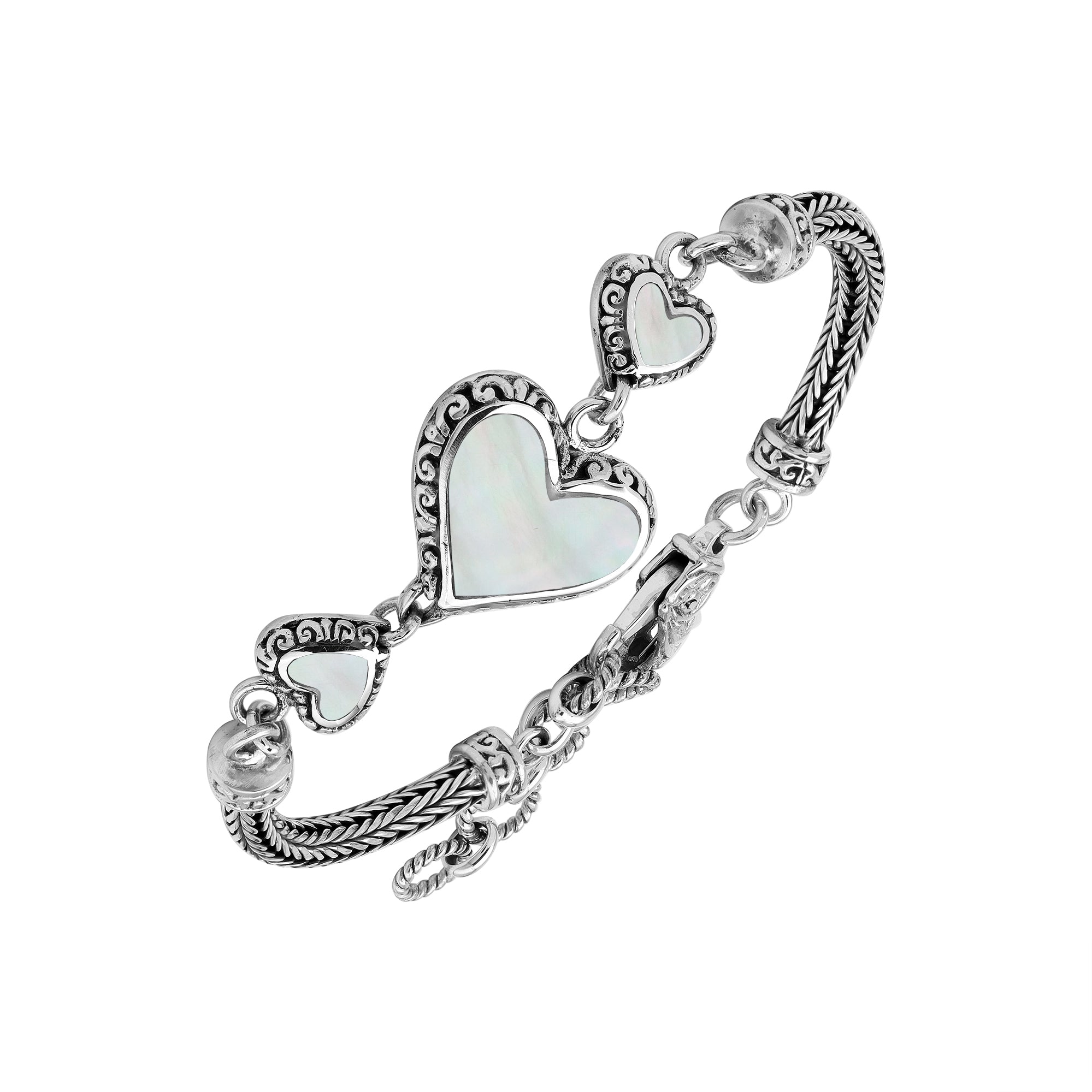 Wholesale sterling silver bracelet featuring Mother Of Pearl heart motifs, ornate Balinese decorative details, and a secure lobster lock for premium artisan-inspired jewelry assortments.