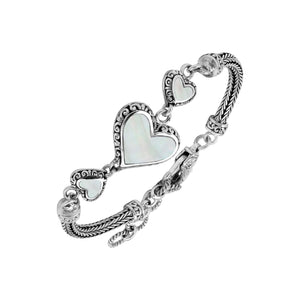 Wholesale sterling silver bracelet featuring Mother Of Pearl heart motifs, ornate Balinese decorative details, and a secure lobster lock for premium artisan-inspired jewelry assortments.