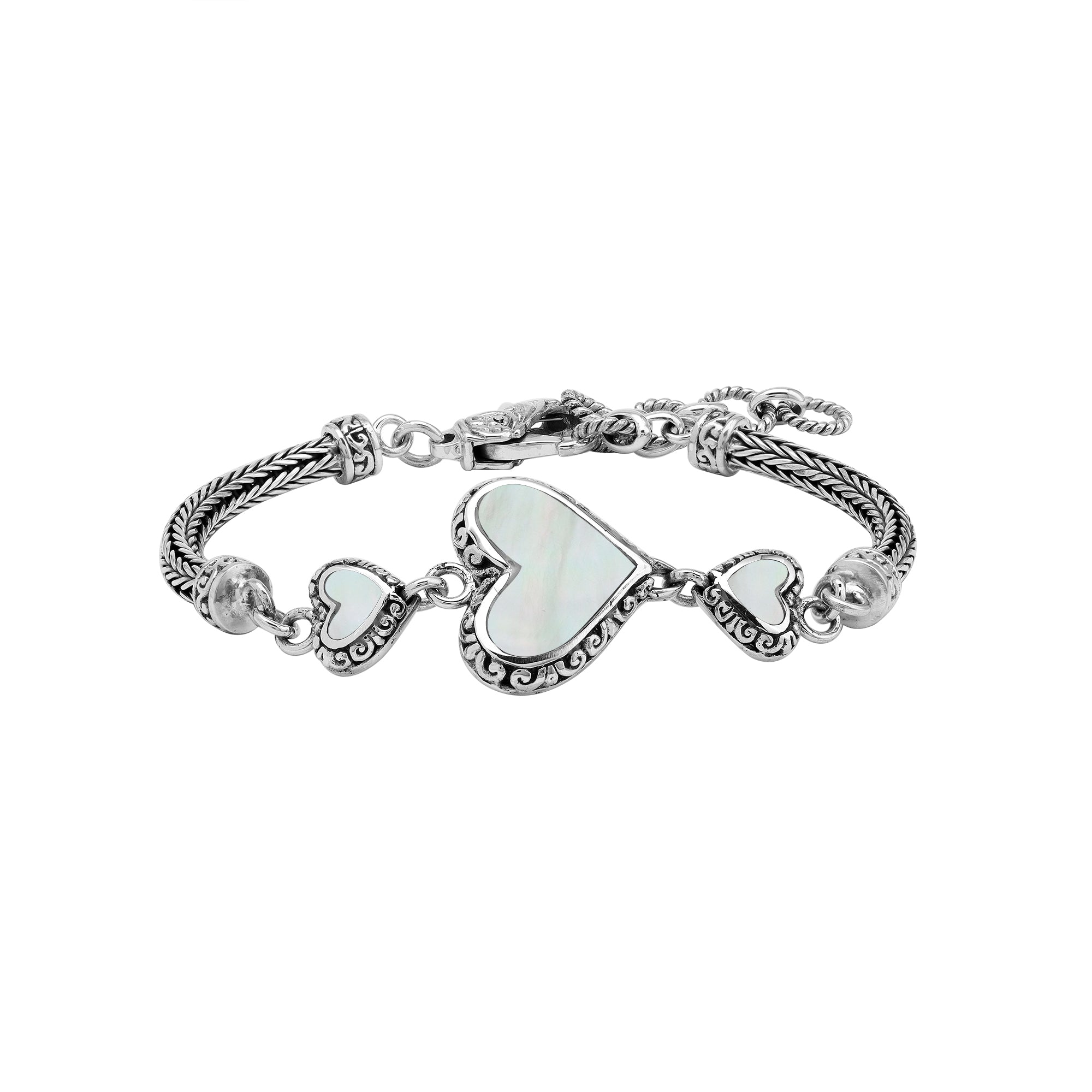 Wholesale sterling silver bracelet featuring Mother Of Pearl heart motifs, ornate Balinese decorative details, and a secure lobster lock for premium artisan-inspired jewelry assortments.