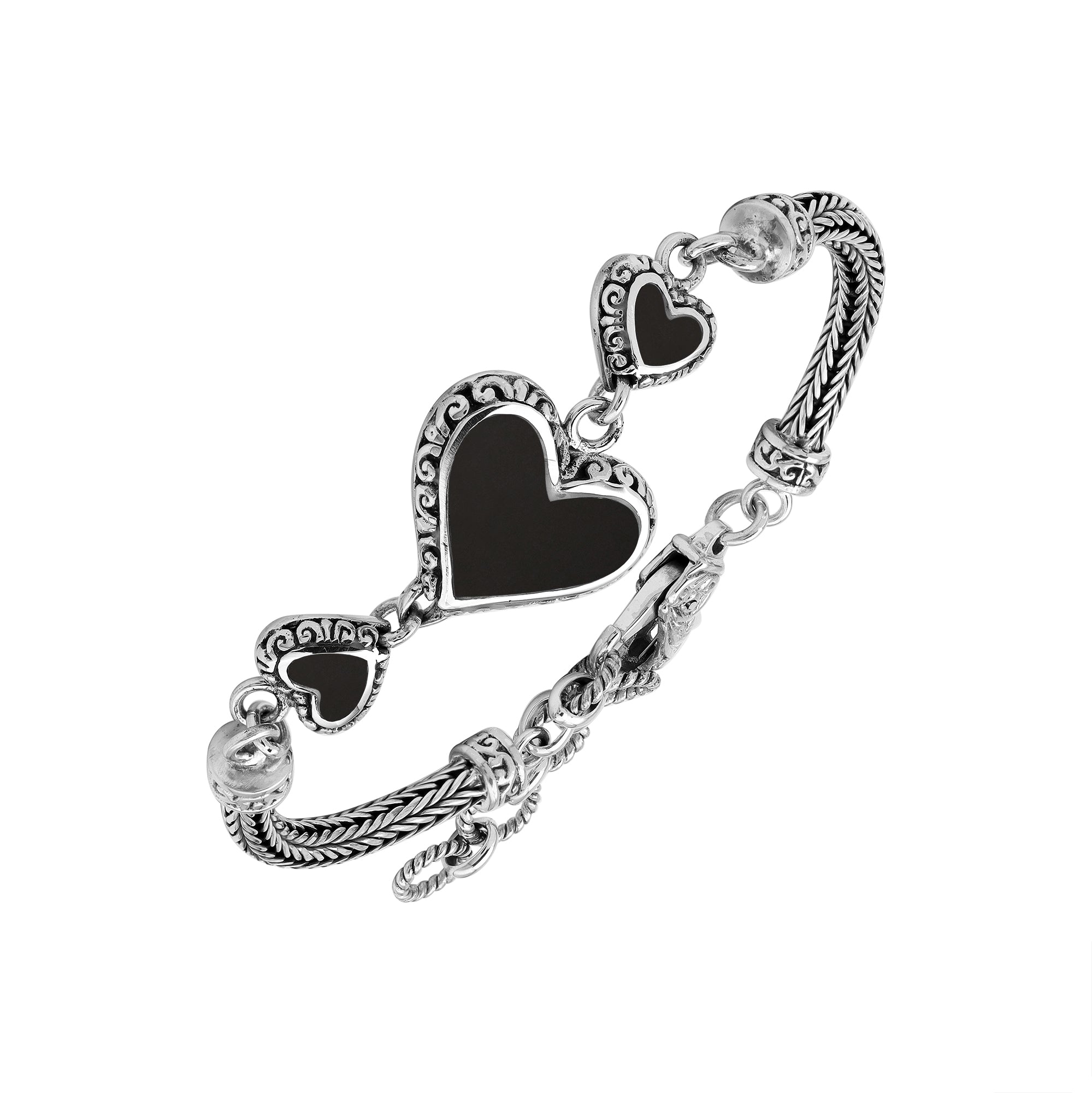 Wholesale sterling silver bracelet featuring Black Shell heart motifs, detailed Balinese ornamental scrollwork, and a secure lobster lock designed for artisan-inspired premium jewelry collections.