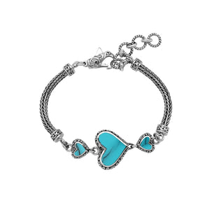 Wholesale sterling silver bracelet featuring Turquoise Shell heart motifs, crafted with intricate Balinese ornamental detailing and secured with a lobster lock for premium artisan-style jewelry collections.
