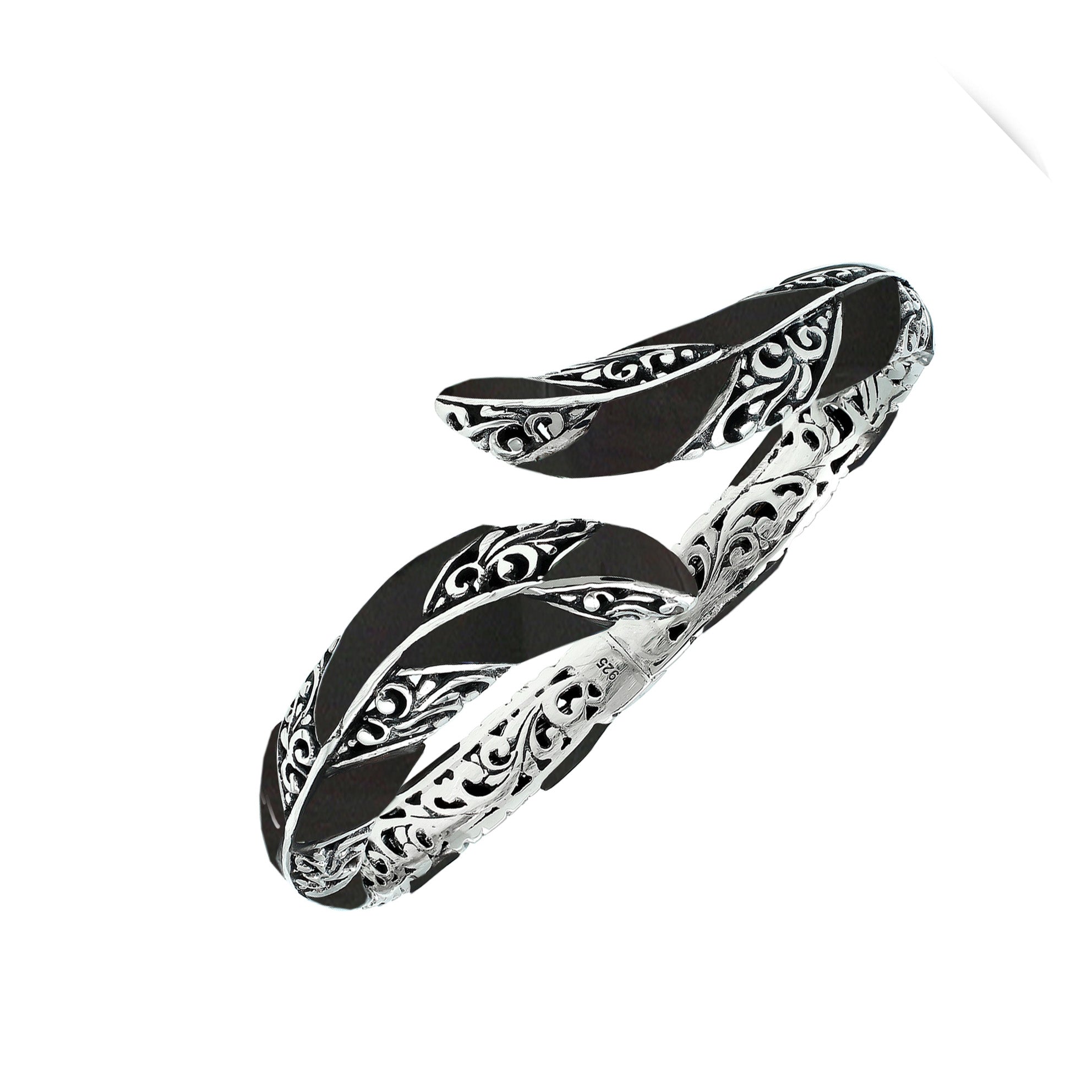 Wholesale sterling silver feather-inspired bangle featuring bold Black Shell inlays, ornate Balinese scroll engraving, and a secure hinge lock for premium artisan-inspired jewelry collections.