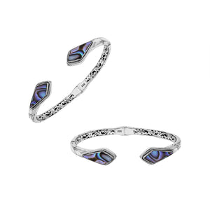 Wholesale sterling silver open bangle featuring Abalone Shell geometric ends, detailed Balinese engravings, and a secure hinge lock for premium artisan-inspired jewelry assortments.