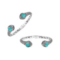 Wholesale sterling silver bangle featuring Larimar double-end stones, ornate Balinese scroll engravings, and a secure hinge lock for artisan-quality jewelry collections.