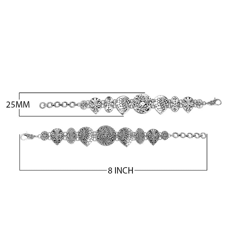 Wholesale sterling silver link bracelet featuring multiple carved Balinese motif shapes, intricate scroll engravings, and a secure lobster lock for premium artisan jewelry assortments.
