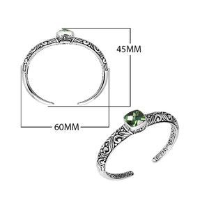 Wholesale sterling silver open bangle with a cushion-cut Green Amethyst Quartz centerpiece, ornate Balinese scroll engravings, and a secure hinge lock for premium artisan jewelry assortments.