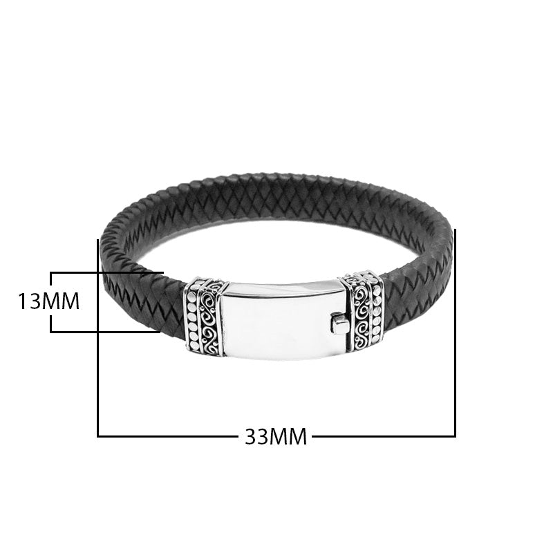 Wholesale sterling silver men’s bracelet featuring a smooth center plate, braided leather band, and secure push clasp crafted with detailed Bali-inspired accents.