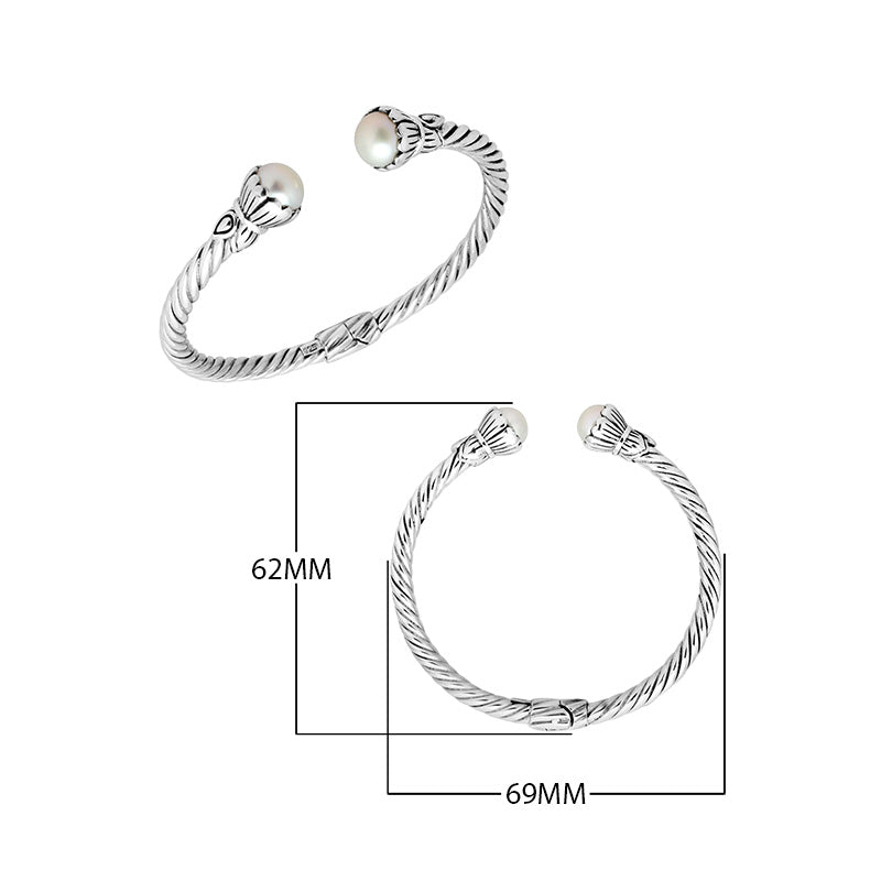 Wholesale sterling silver twisted cable cuff bracelet featuring smooth Mabe pearl end caps, hinge lock, and artisan detailing for premium jewelry assortments.