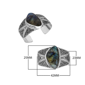 Wholesale sterling silver cuff bracelet featuring a large labradorite stone surrounded by detailed Bali filigree patterns, crafted for premium bulk jewelry selections.