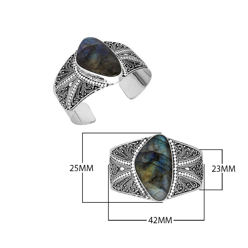 Wholesale sterling silver cuff bracelet featuring a large labradorite stone surrounded by detailed Bali filigree patterns, crafted for premium bulk jewelry selections.