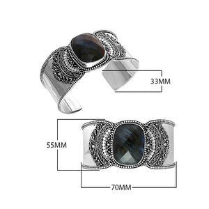 Wholesale sterling silver Bali engraved wide cuff bracelet featuring a bold labradorite centerpiece, enhanced with polished–oxidized detailing for premium bulk jewelry selection.