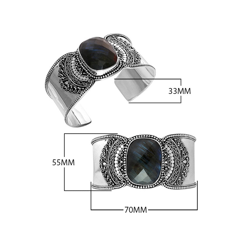 Wholesale sterling silver Bali engraved wide cuff bracelet featuring a bold labradorite centerpiece, enhanced with polished–oxidized detailing for premium bulk jewelry selection.