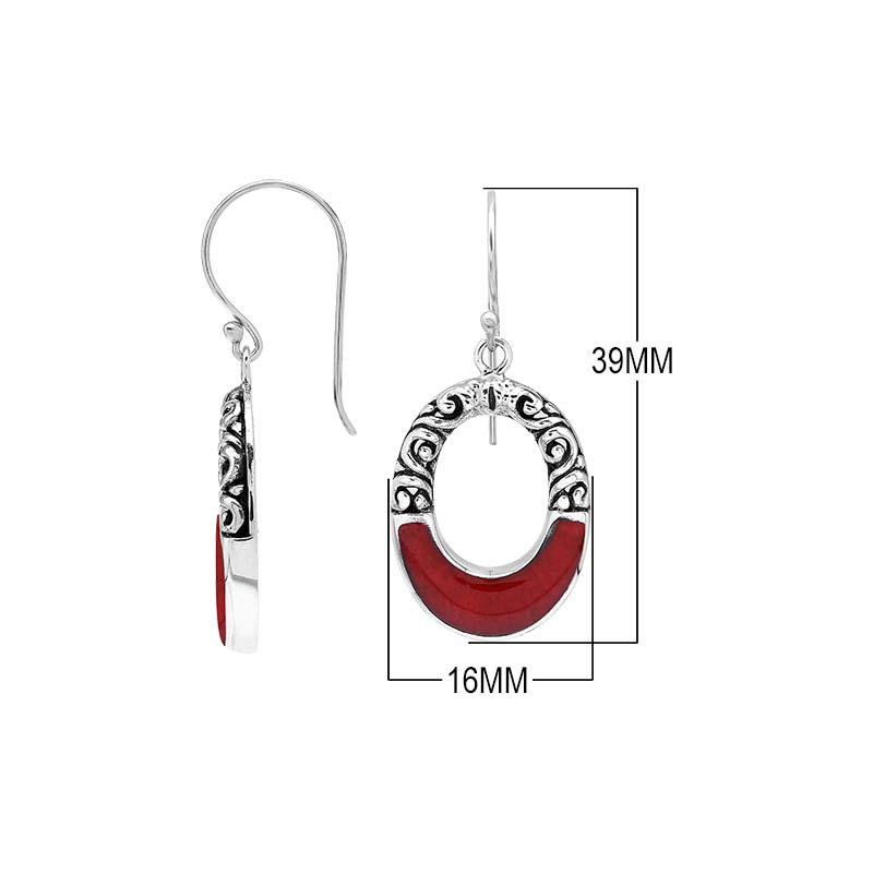 Sterling silver oval drop earrings featuring rich Red Coral inlay, open center design, sculpted scroll motifs, oxidized detailing, polished borders, and French ear wires.