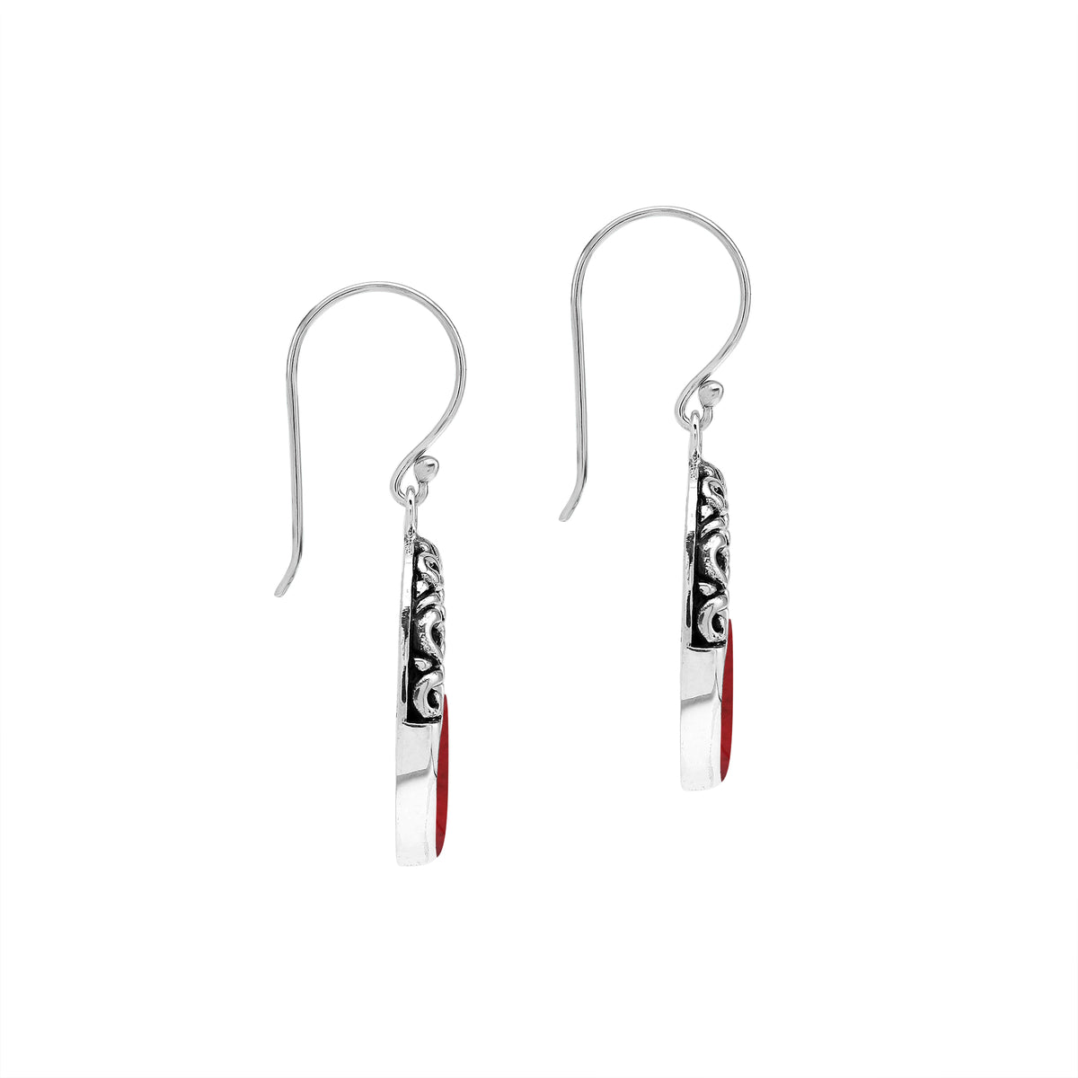 Sterling silver oval drop earrings featuring rich Red Coral inlay, open center design, sculpted scroll motifs, oxidized detailing, polished borders, and French ear wires.