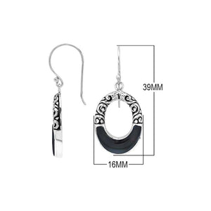 Sterling silver oval drop earrings featuring glossy Black Shell inlay, open center silhouette, sculpted scroll motifs, oxidized detailing, polished borders, and French ear wires.
