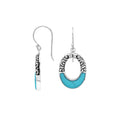 Sterling silver oval drop earrings featuring vibrant Turquoise Shell inlay, open center silhouette, sculpted scroll motifs, oxidized detailing, polished borders, and French ear wires.
