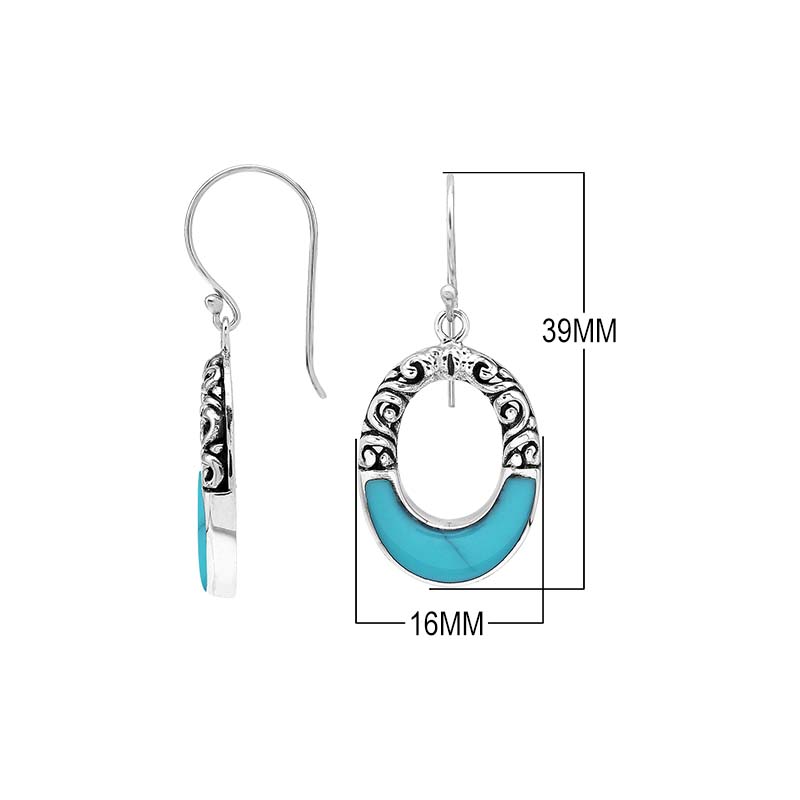 Sterling silver oval drop earrings featuring vibrant Turquoise Shell inlay, open center silhouette, sculpted scroll motifs, oxidized detailing, polished borders, and French ear wires.