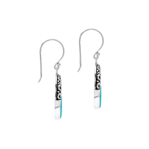 Sterling silver oval drop earrings featuring vibrant Turquoise Shell inlay, open center silhouette, sculpted scroll motifs, oxidized detailing, polished borders, and French ear wires.