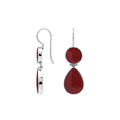 Sterling silver Red Coral dangle earrings featuring a round upper element and teardrop lower drop, polished bezel settings, articulated construction, and elongated ear wires.