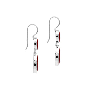 Sterling silver Red Coral dangle earrings featuring a round upper element and teardrop lower drop, polished bezel settings, articulated construction, and elongated ear wires.